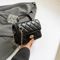 Quilted black mini backpack with gold chain strap and elegant metallic twist lock - Black