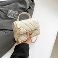 Elegant cream quilted mini bag with gold chain strap and turn-lock closure in chic style - White