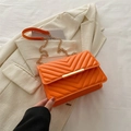 Orange quilted rectangular crossbody bag with V-shaped stitching and gold chain strap - Orange