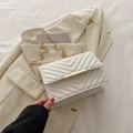 Elegant white crossbody bag featuring V-quilted faux leather and gold metal clasp - White
