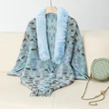 Detail of blue knitted shawl featuring faux fur collar and vibrant abstract pattern - Letter F / Blue