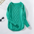Detail of turquoise cable-knit sweater featuring amber button accents and ribbed texture - S / Green