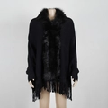Elegant black knit poncho with luxury faux fur collar and fringe hem on mannequin - One Size / Black