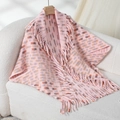Pink knit shawl with orange spots and long fringe trim on a wooden hanger - Letter F / Pink