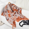 Detail of knit leopard print shawl with long orange tassels and soft knit texture - Letter F / Khaki
