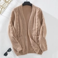 Close-up of cable knit cardigan sweater featuring ribbed cuffs and two front pockets - S / Khaki