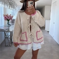 Women's beige loose knit cardigan with pink plush trim and front bow tie closure - S / Off White