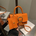 Orange lychee leather crossbody bag with gold buckle and matching small coin purse - Orange