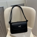 Minimalist black matte faux leather crossbody bag featuring a silver bow metal buckle - Black