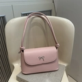 Pale pink leather shoulder bag featuring a silver metal bow accent and knotted strap - Pink