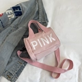 Rosafarbene zylindrische Sporttasche mit weißem PINK-Buchstabenaufdruck und Tragegurt - Rosa