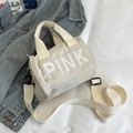 Beige zylindrische Sport-Handtasche mit weißem PINK-Schriftzug und Schultergurt - Weiß