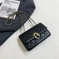 Black quilted crossbody bag with gold U-shaped buckle and metal chain strap - Black