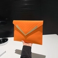 Orange envelope clutch bag with V-shaped gold metal trim and stitching details - Orange
