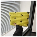 Quilted yellow makeup bag with black bow embroidery and a compact handheld design - Yellow