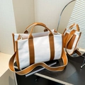 Minimalist white canvas tote bag with brown leather trim and adjustable shoulder strap - Brown