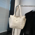Minimalist off-white canvas tote bag with side pockets and front metal snap button pocket - White