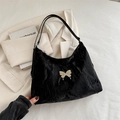 Black pleated tote bag with silver metal butterfly detail and long shoulder strap - Black