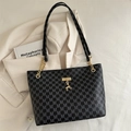 Dark gray tote bag with letter prints, gold chain strap, and deer charm on cream background - Black