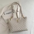 Beige tote bag with brown M-pattern print, gold deer charm and chain strap detail - White