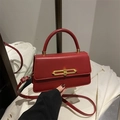Elegant red faux leather crossbody bag with round handle and golden buckle for women - Red