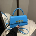 Minimalist sky blue crossbody box bag with unique gold chain buckle and top handle - Blue