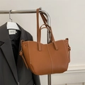 Brown lychee leather tote bag with white contrast stitching and tie-knot detail - Brown