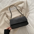 Retro black baguette bag with woven texture and slim leather shoulder strap - Black