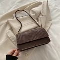 Minimalist dark brown underarm bag with woven texture detail and golden metal buckle - Brown