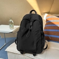 Lightweight black nylon backpack featuring drawstring front pocket and mesh side pouches - Black