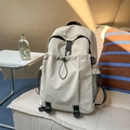 Beige large capacity backpack featuring drawstring front pocket and side mesh storage - White
