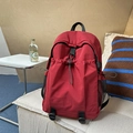 Red large capacity backpack for students featuring drawstring pockets and black side mesh - Red