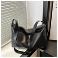Detail of black soft PU leather Boston bag featuring gold buckle and smooth zipper closure - Black