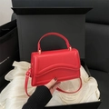 Chic red faux leather handbag with wave stitching detail and adjustable shoulder strap - Red