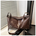Detailed shot of dark brown faux leather tote showing the wide strap and golden buckle - Brown
