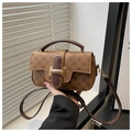 Detail of vintage caramel leather crossbody bag with clover pattern and gold buckle - Brown