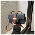 Close-up of contrast leather handle and golden H-shaped buckle on small square bag - Black