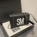 Minimalist black faux leather shoulder bag featuring a bold white SM letter logo and chain - Black