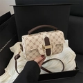 Beige vintage floral crossbody bag with brown leather handles and gold metal clasp - White