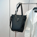 Black leather tote bag with embossed skull patterns and rhinestone skull detail - Black