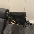 Modern black crinkled clutch bag featuring a gold metal trim and wristlet strap - Black