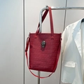Red tote bag with skull embossing and metal skull detail on adjustable strap - Red