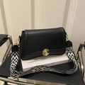 Classic black lychee pattern leather crossbody bag with geometric woven strap and gold buckle - Black