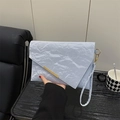 Light blue textured envelope clutch bag with gold metal trim and detachable wristlet - Blue
