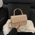 Elegant beige quilted handbag with gold lock and top handle displayed in a luxury gift box - Khaki