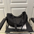 Minimalist black crescent crossbody bag with drawstring detail and wide shoulder strap - Black