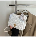 Detail of white quilted handbag featuring gold diamond clasp and silk scarf wrapped handle - White