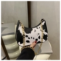Cow print crescent shoulder bag with a gold metal chain strap and minimalist design - Cow Print