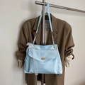 Light blue faux leather handbag featuring white lace bow and gold-tone metal twist lock - Blue