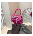 Close-up of rose pink sequin mini bag with rhinestone bow and silver chain strap - Rose Red
